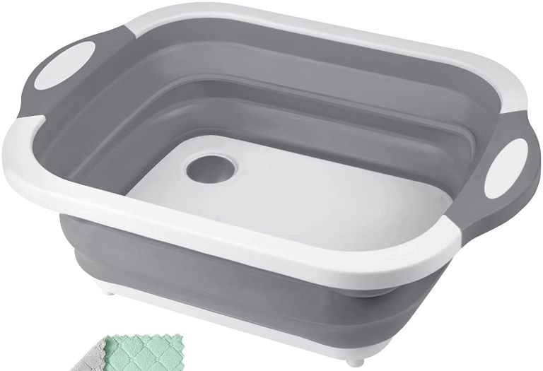 White and grey collapsible camping sink with cutting board bottom.