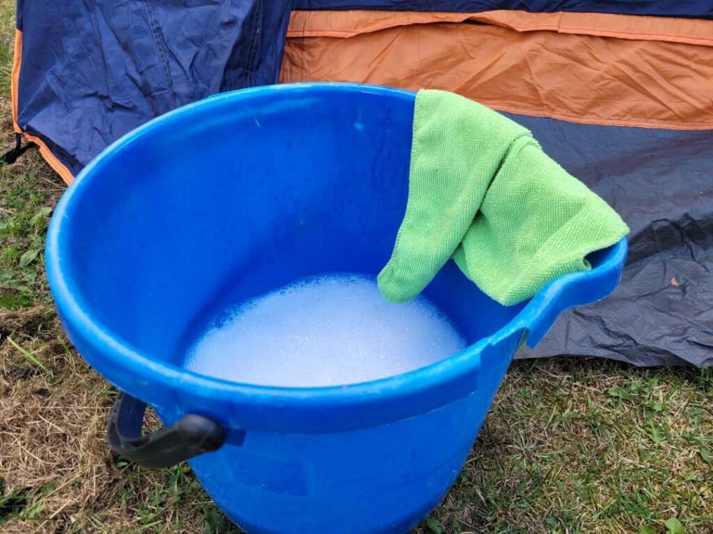 Blue wash bucket and green cloth
