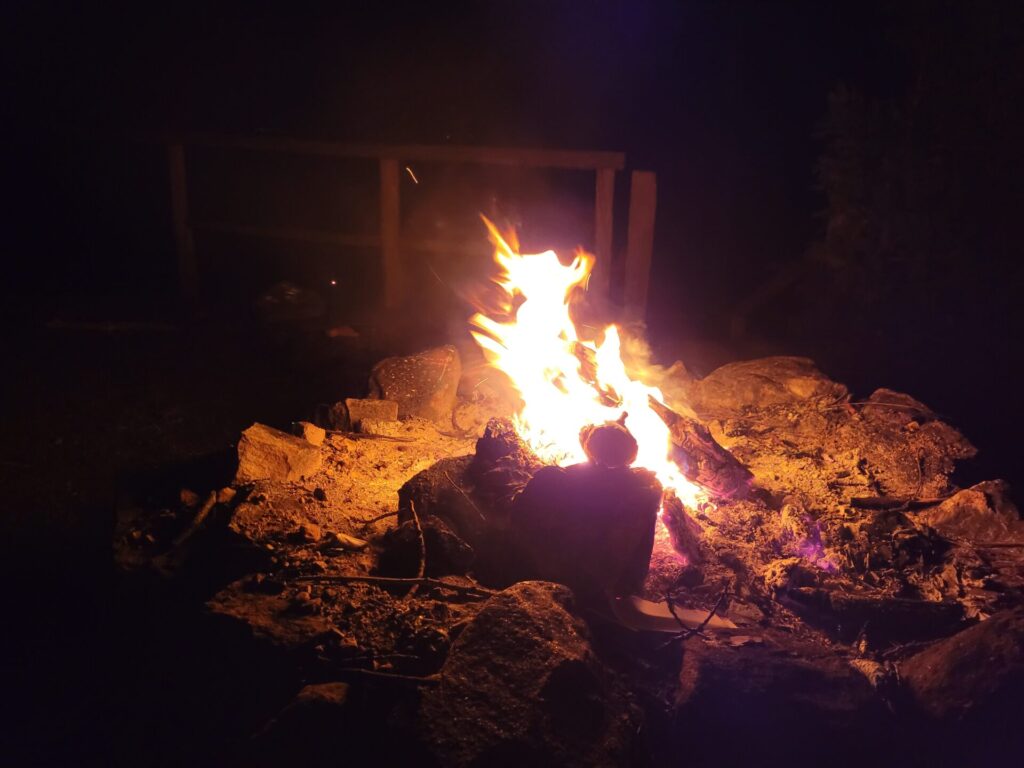 A campfire on a dark night