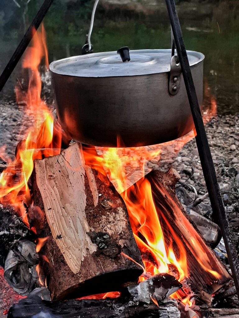 A pot of chili over an open flame
