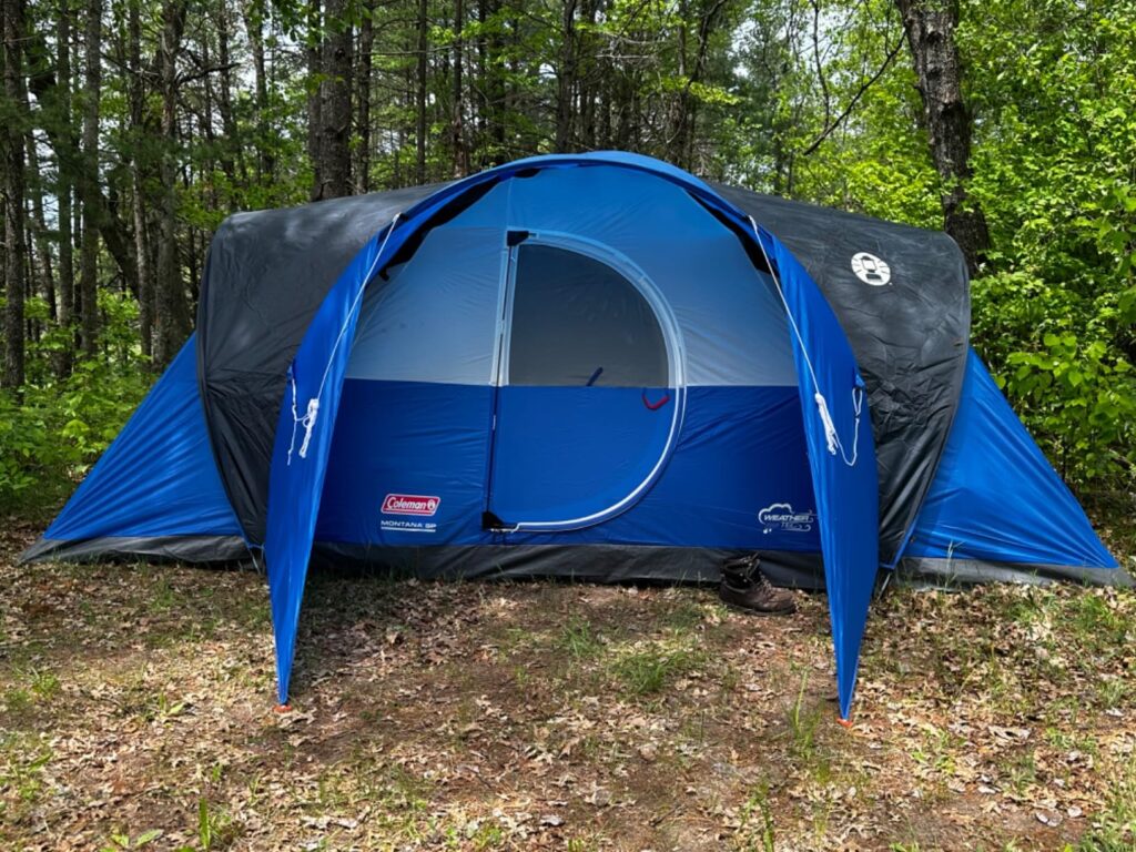 A blue Coleman Montana tent at a campground